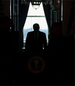 Donald Trump in darkened Oval Office