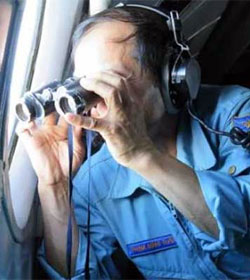 Malaysia Flight 370 searcher with binoculars