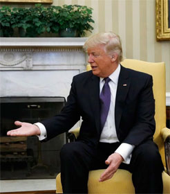 Donald Trump extending his hand to a reluctant Justin Trudeau (not shown)