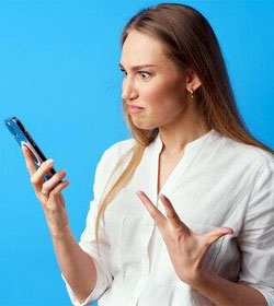 Frustrated woman looking at phone